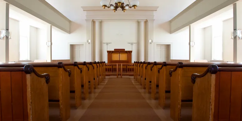 Symmetrical rows of pews in church