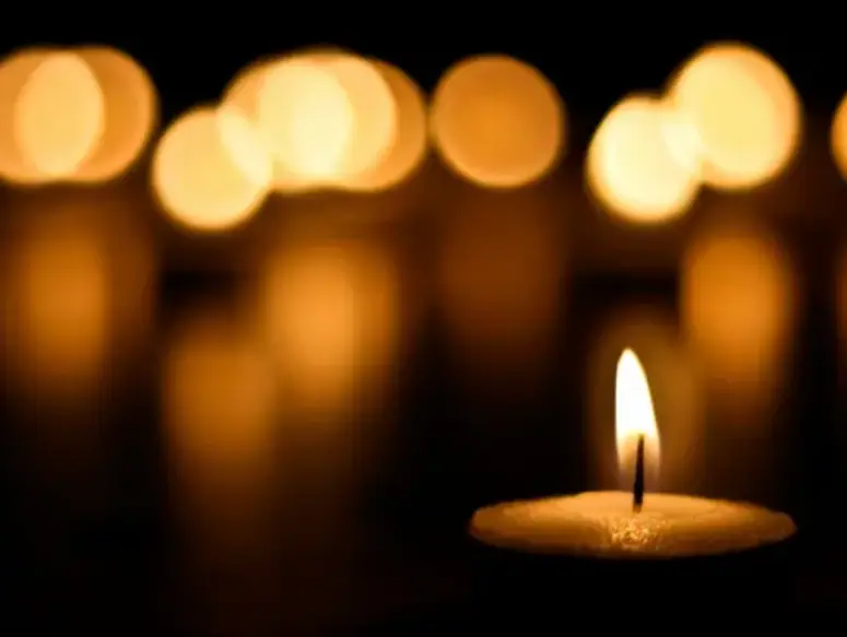 Warm candle flame with blurred lights