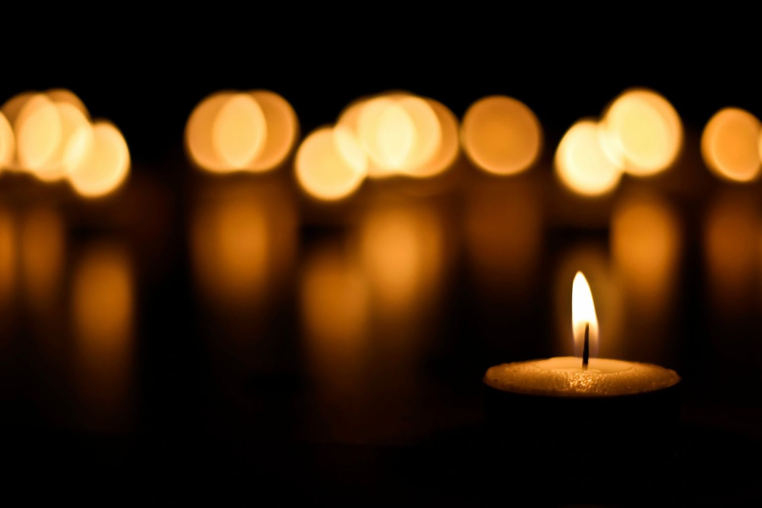 Lit candle with soft bokeh lights