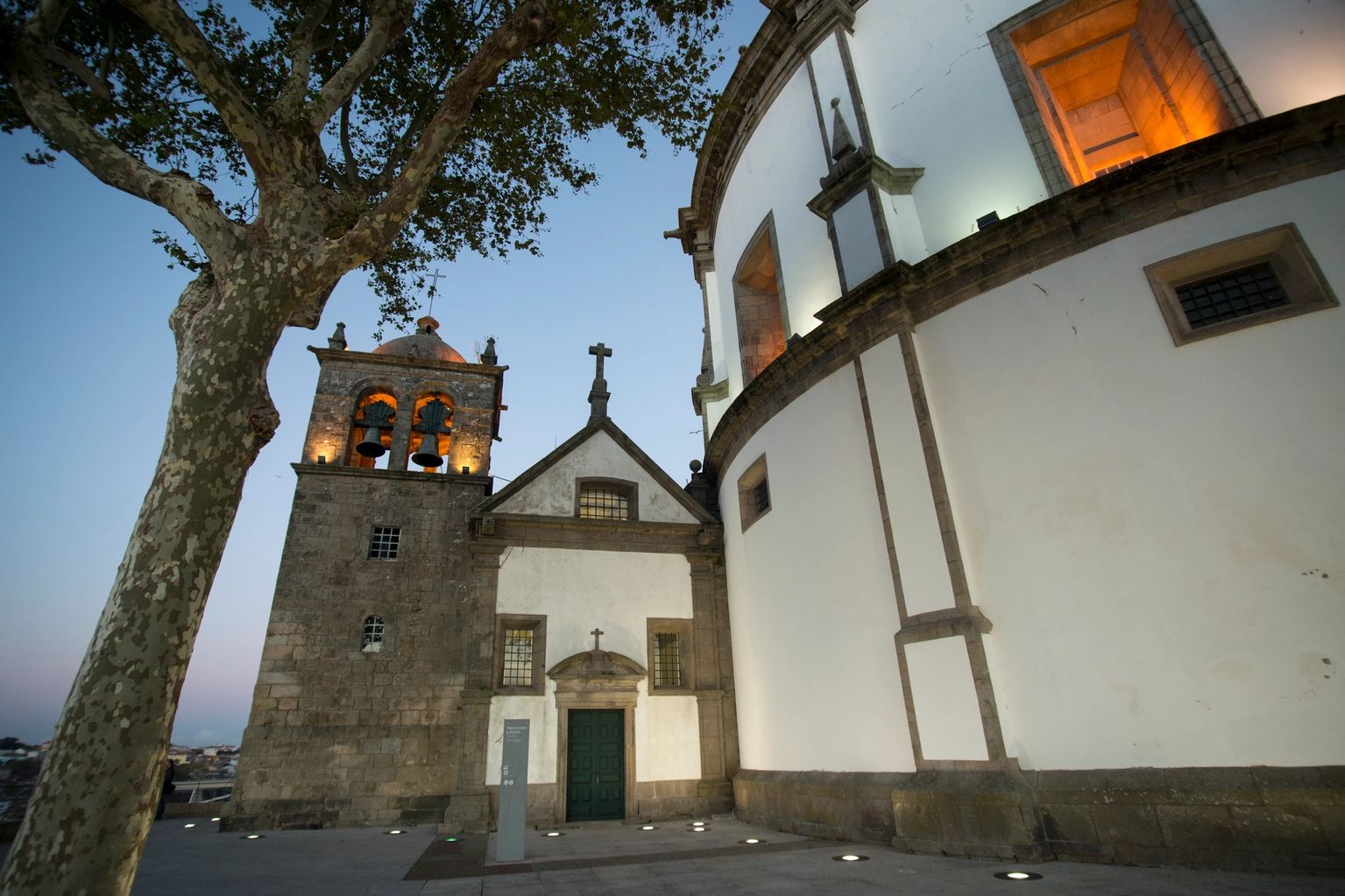 Historic stone church with bell tower at dusk
