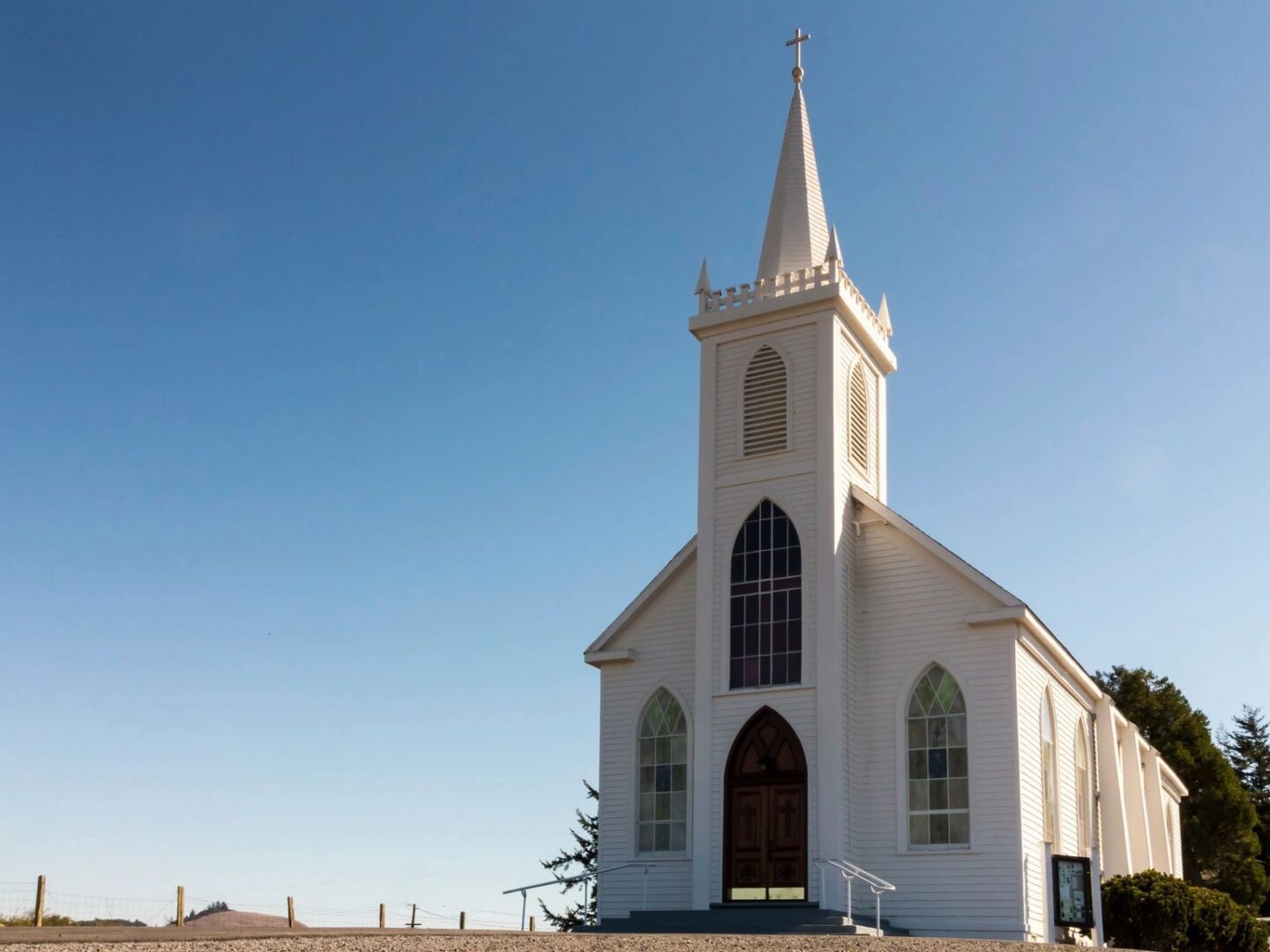 White wooden church with tall steeple