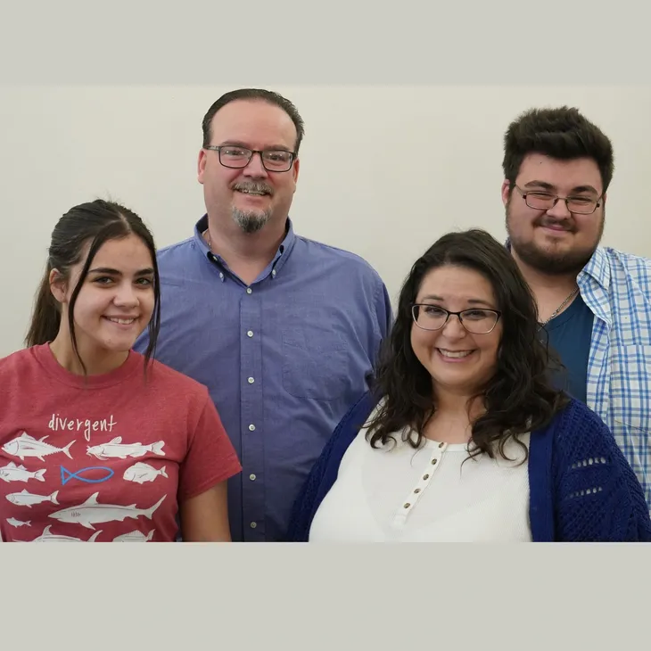 Group portrait of four smiling adults