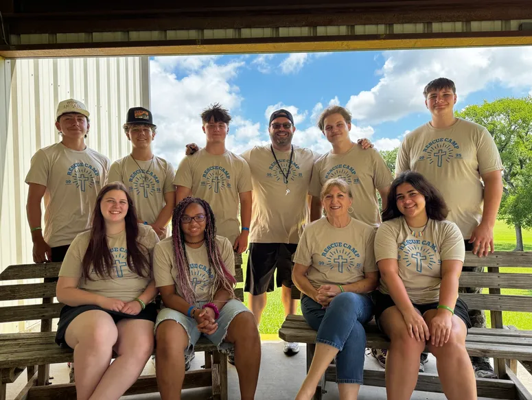 Group wearing matching camp shirts outdoors