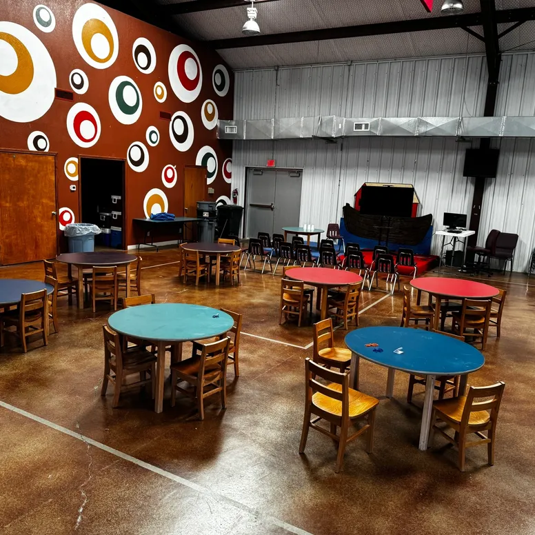 Colorful children's activity room with round tables